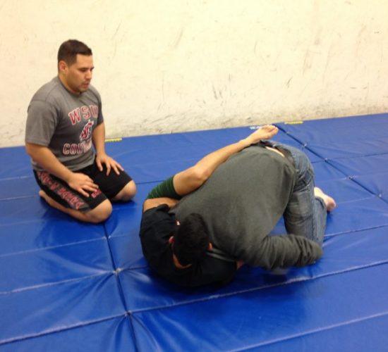 Jiu-Jitsu club members rolling on mats