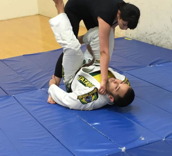 Jiu-Jitsu club members rolling on mats