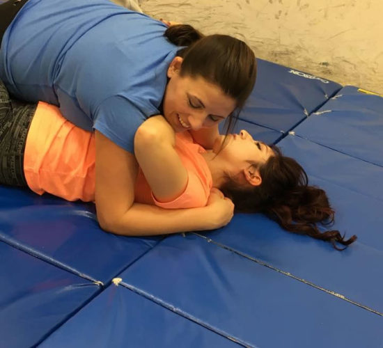 Jiu-Jitsu club members rolling on mats