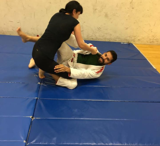 Jiu-Jitsu club members rolling on mats