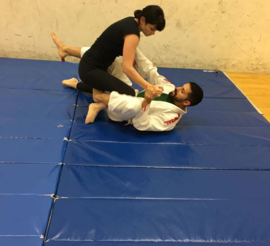 Jiu-Jitsu club members rolling on mats