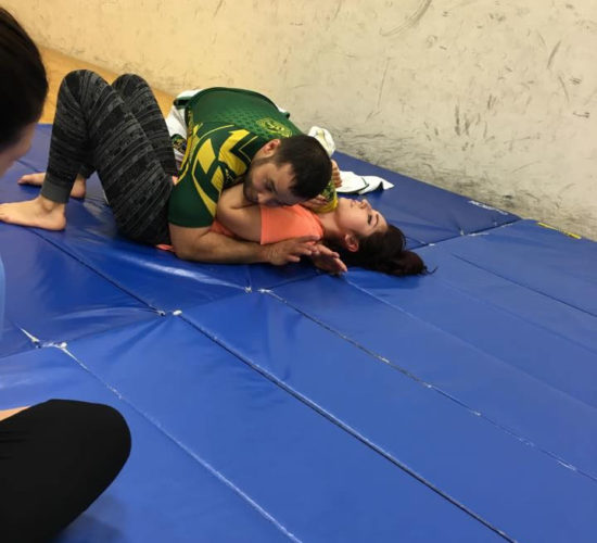 Jiu-Jitsu club members rolling on mats