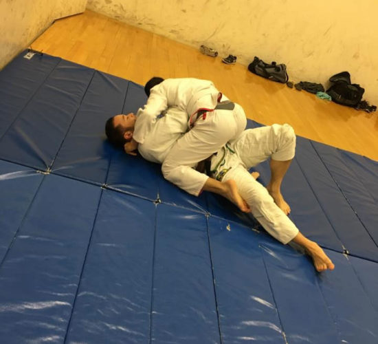 Jiu-Jitsu club members rolling on mats