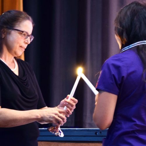 Nursing Student lighting candle