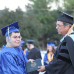 Graduate shaking hands with Trustee 