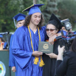 Graduate hugging faculty member