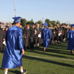 students entering the field for ceremony
