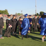 students entering the field for ceremony