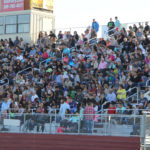 family and friends in the stands waiting for graduates to enter