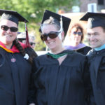 team of 3 faculty waiting for ceremony