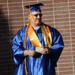 male graduate waiting to line up for ceremony