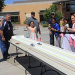 teacher and students at car solar race station