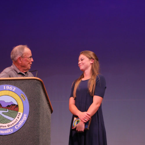 Teacher giving student award