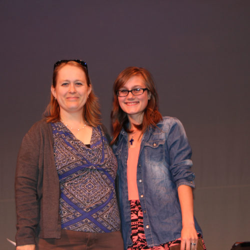 Teacher giving student award