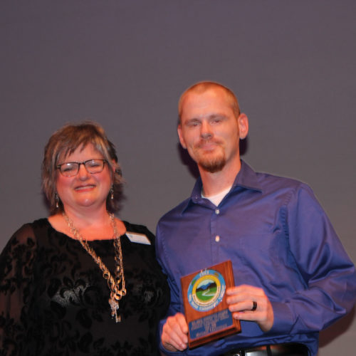 Teacher giving student award