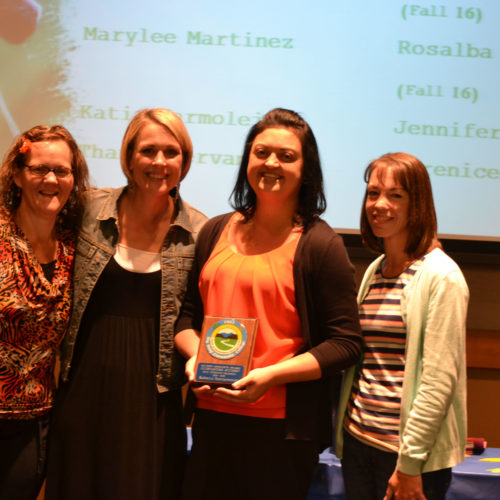 Teacher giving students award