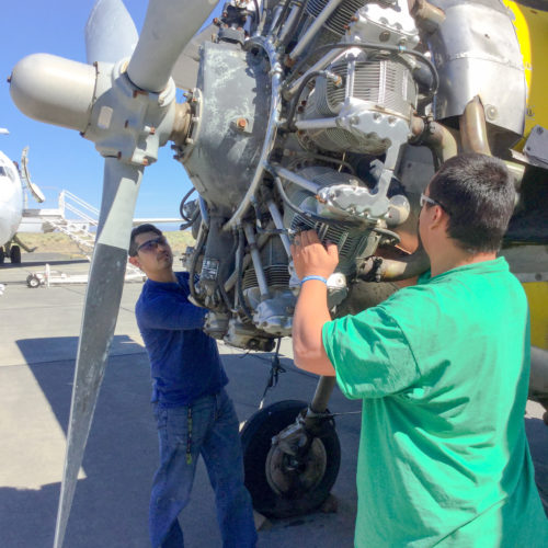 Students working on airplane