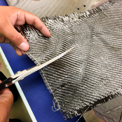 Student cutting fabric