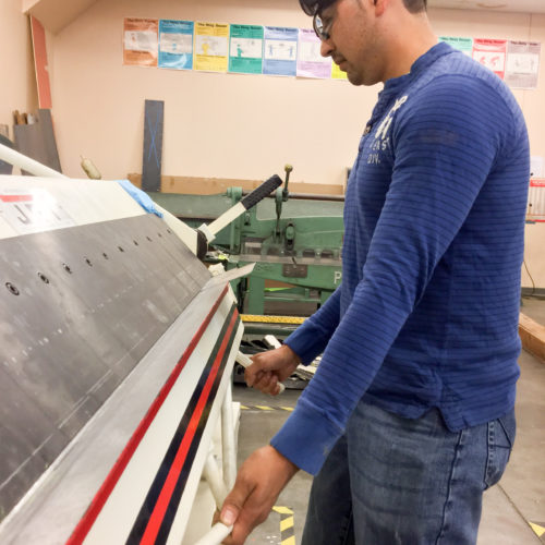 Student working with airplane fin