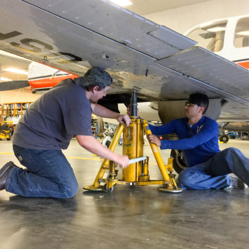 Students lifting wing with a jack