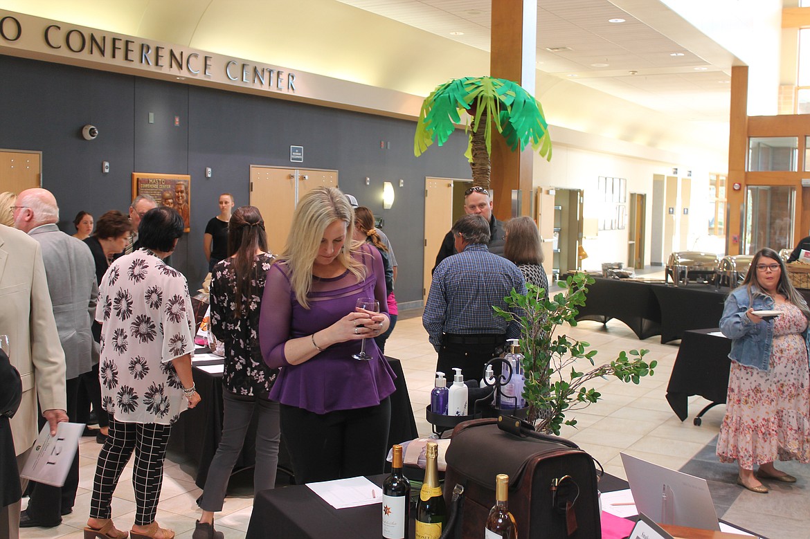 Cellarbration attendee looks at auction items