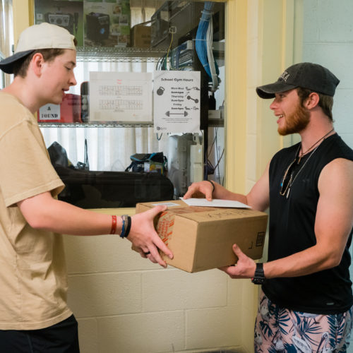 RA hands student a package