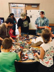 Group of students looking at comic books