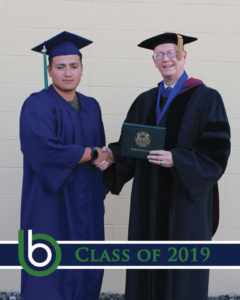 President and student receiving diploma