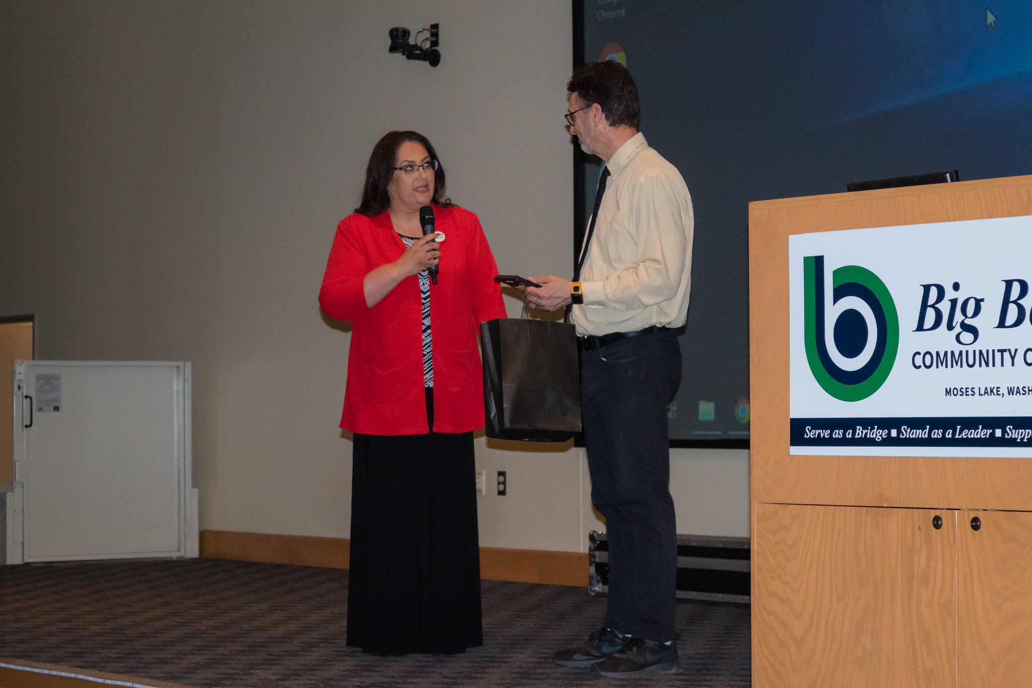 trio director Anita De Leon handing out award to instructor