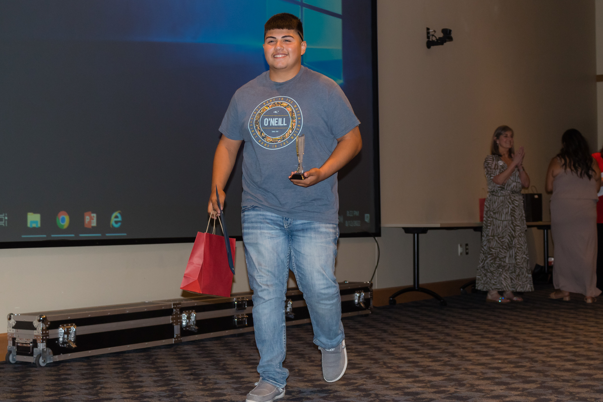 male student smiling after getting award