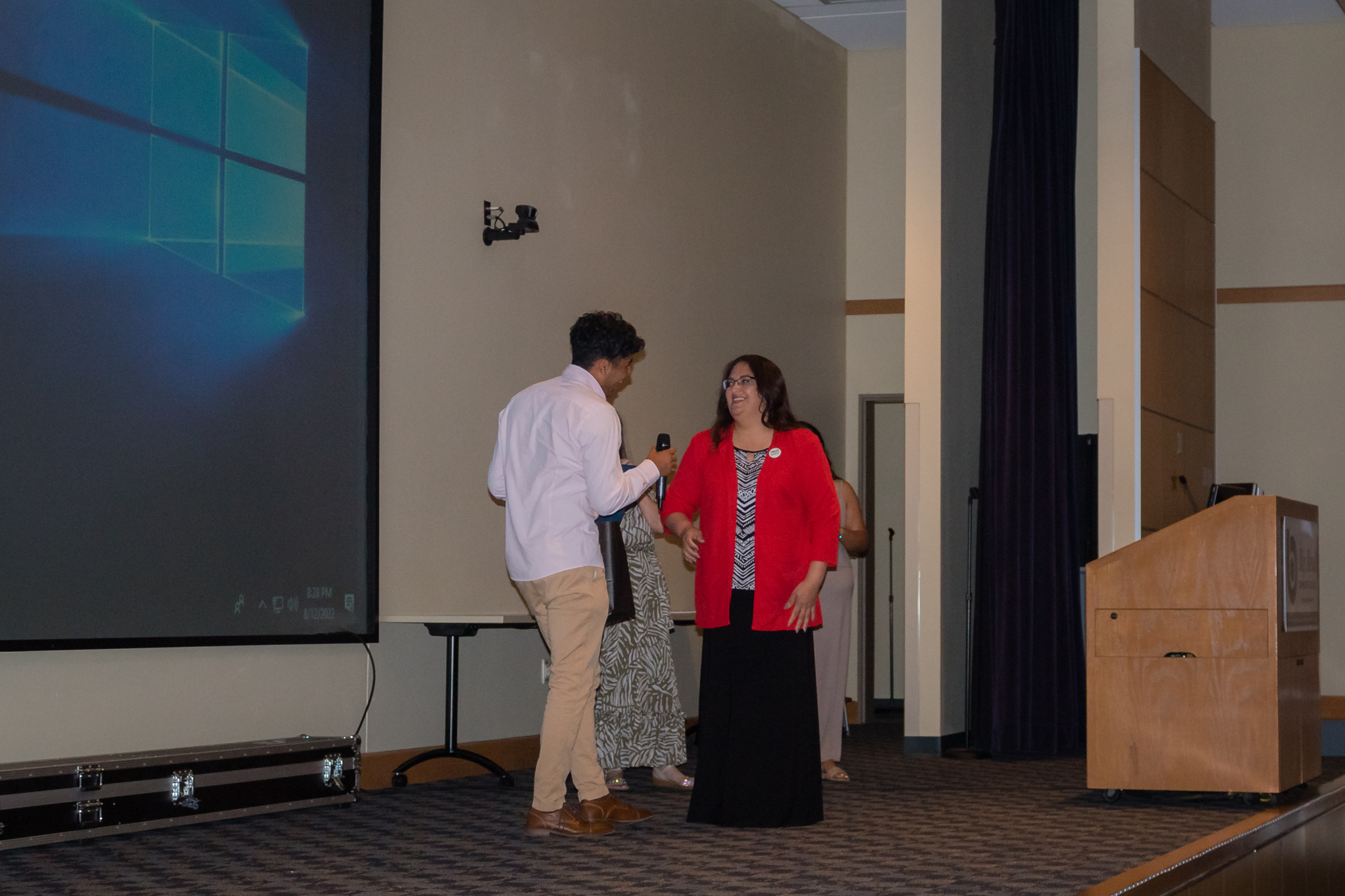 TRIO upward bound director Anita De Leon hands award to male student