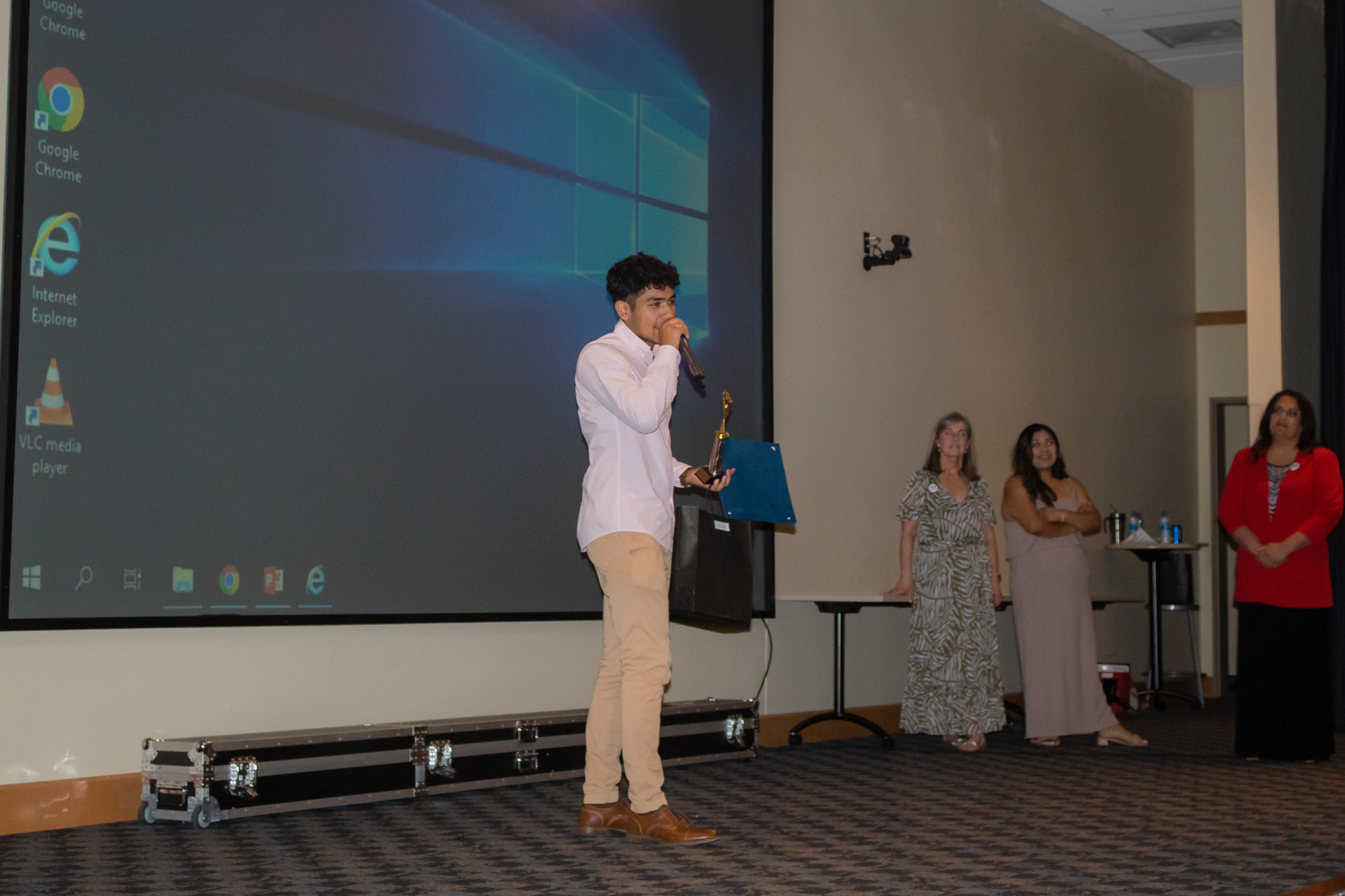 male student smiling after getting award