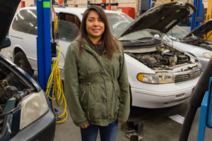 student in a car garage