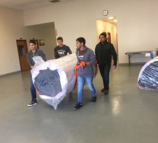 Jiu-Jitsu club members moving mats