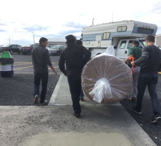 Jiu-Jitsu club members unloading mats off pickup truck