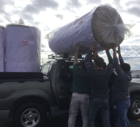 Jiu-Jitsu club members unloading mats off pickup truck