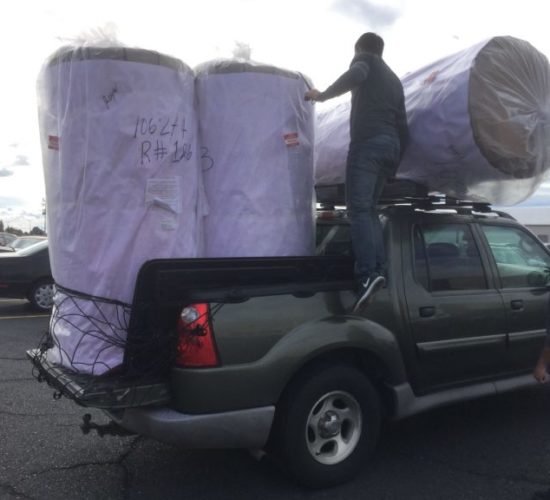 Jiu-Jitsu club members unloading mats off pickup truck