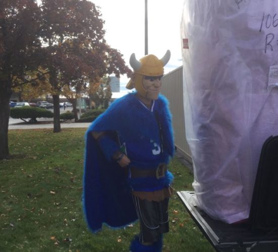 Jiu-Jitsu club members moving mats with Viking Mascot