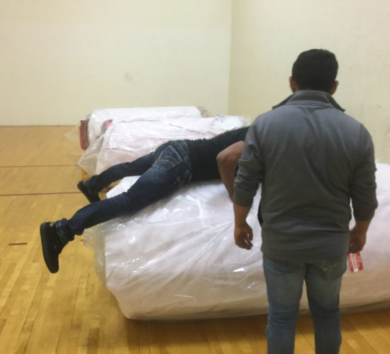 Jiu-Jitsu club members unrolling mats