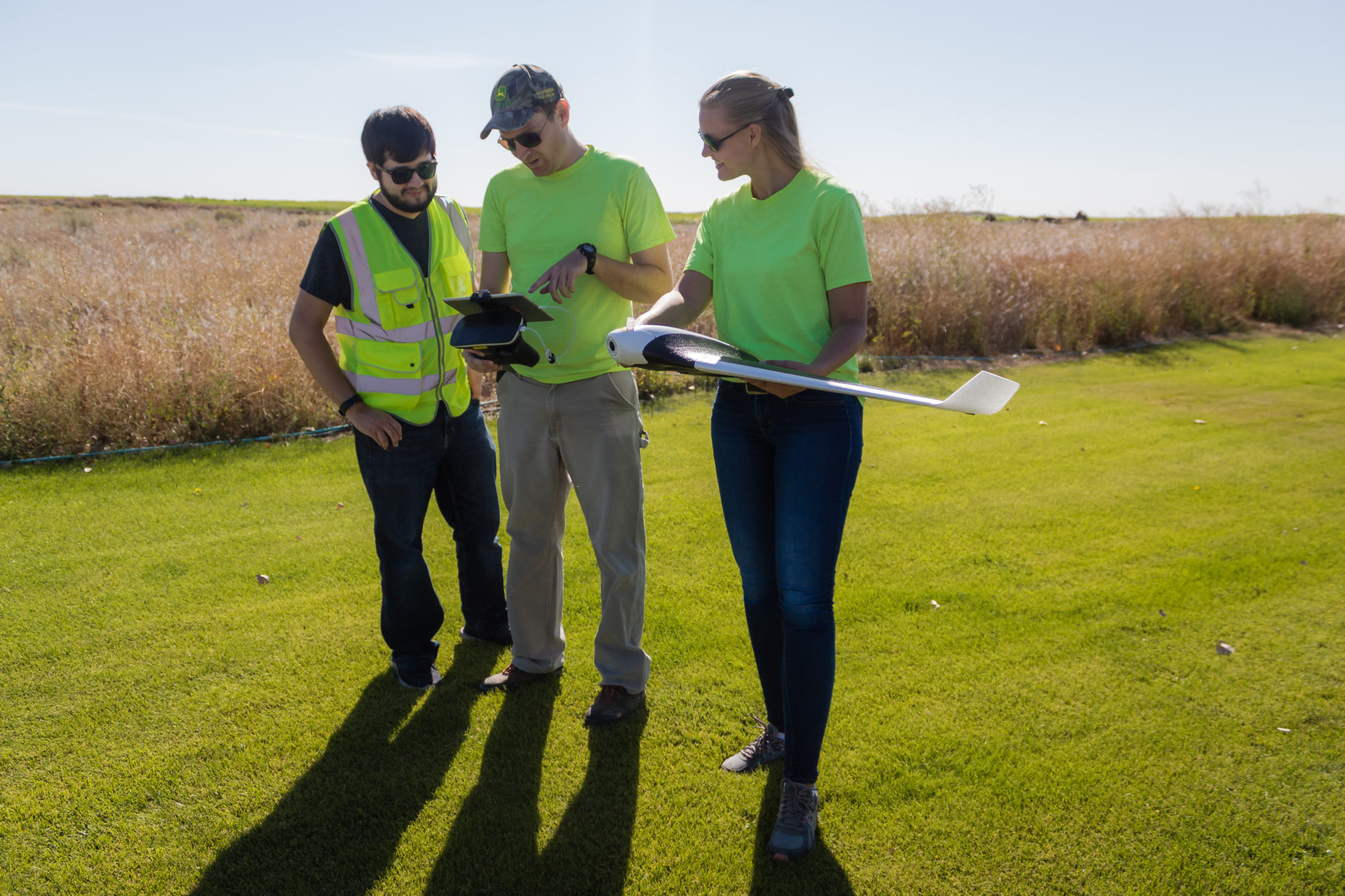 Instructor and students holding drones