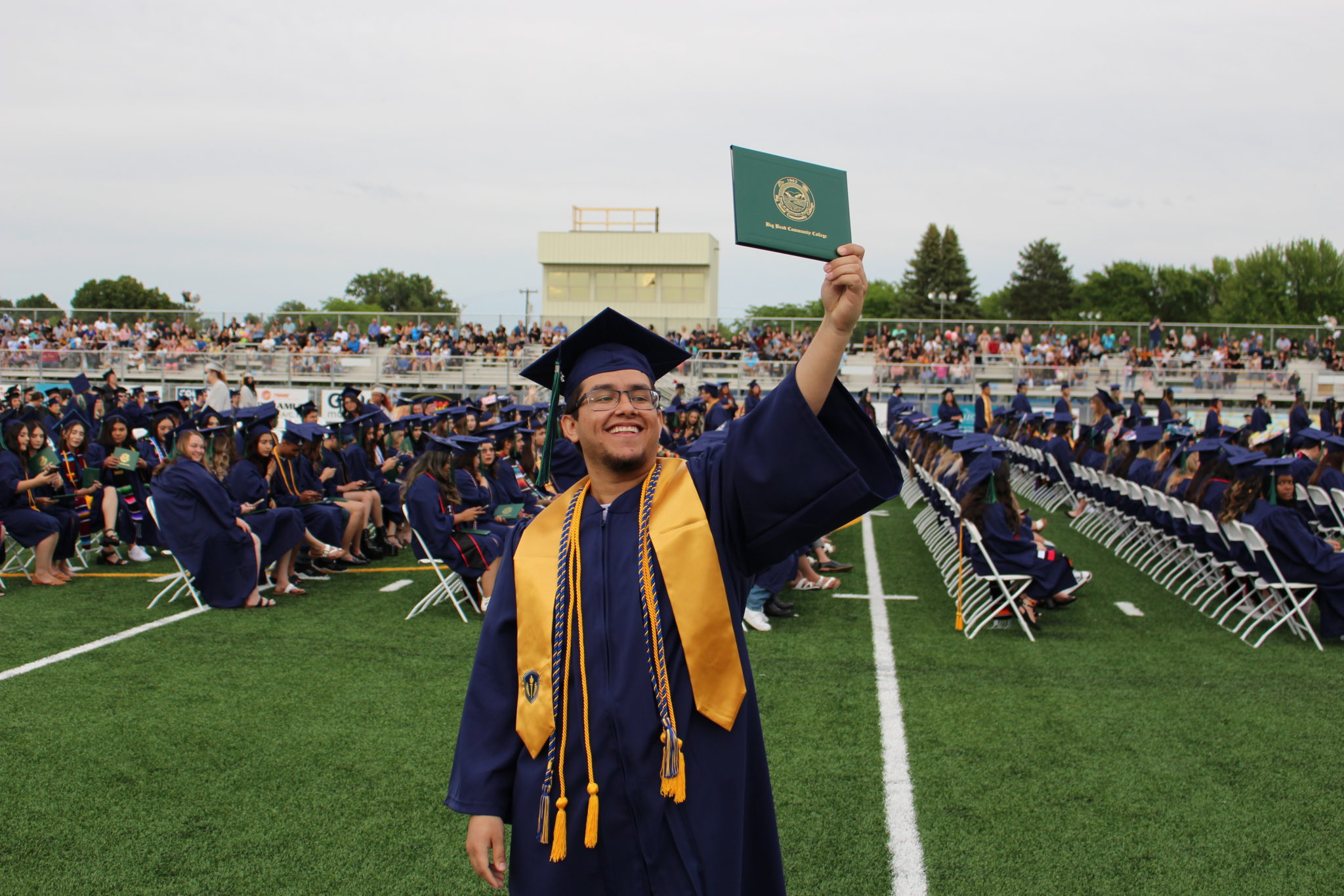 graduate holding diploma