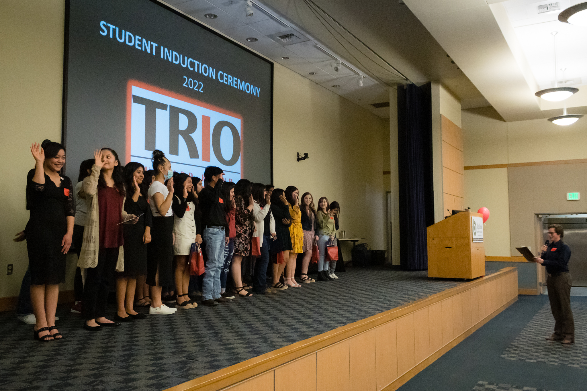 trio students raise their hands to take the TRIO pledge