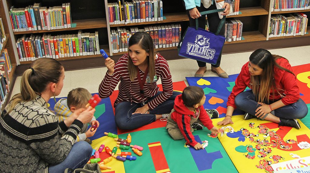 leaders with children in library