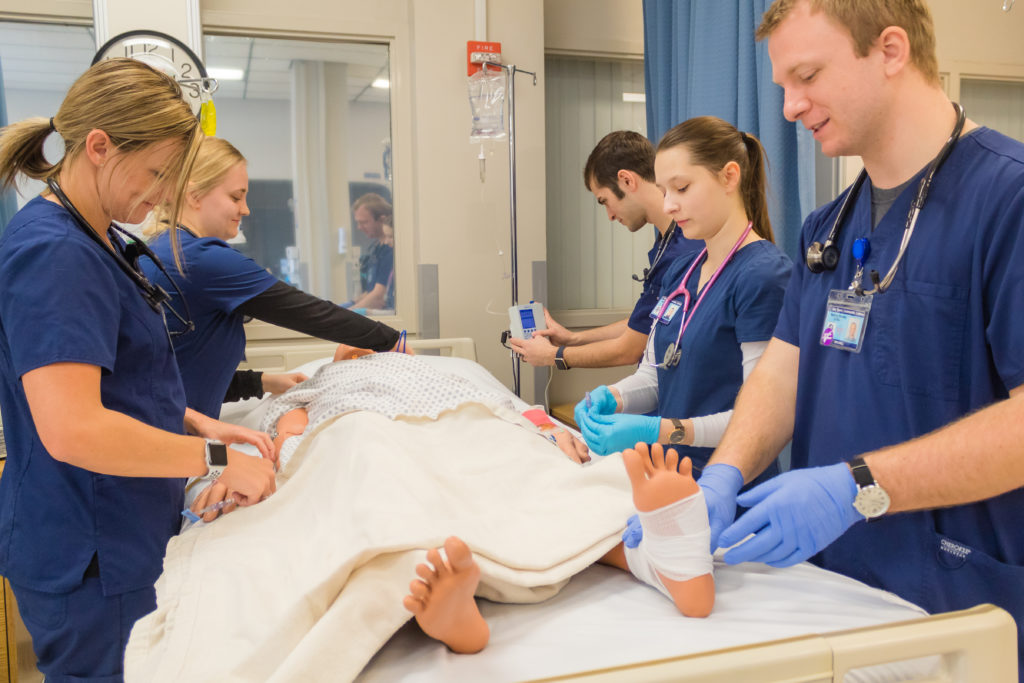 Nursing students working on manikin