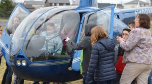 Students surrounding a helecopter