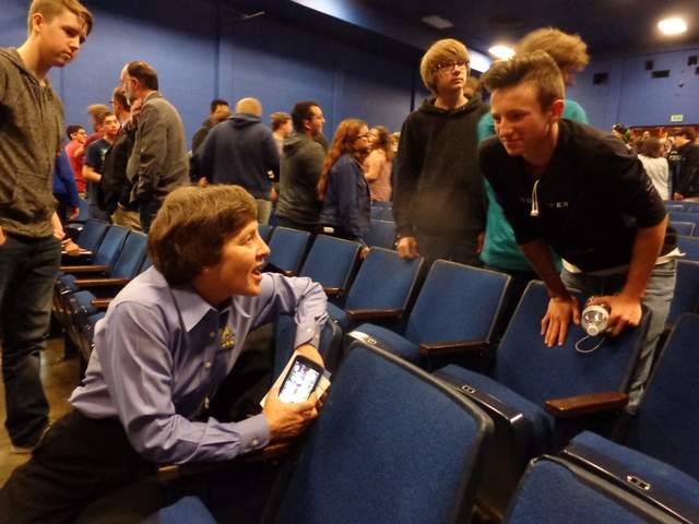 students talking with astronaut speaker