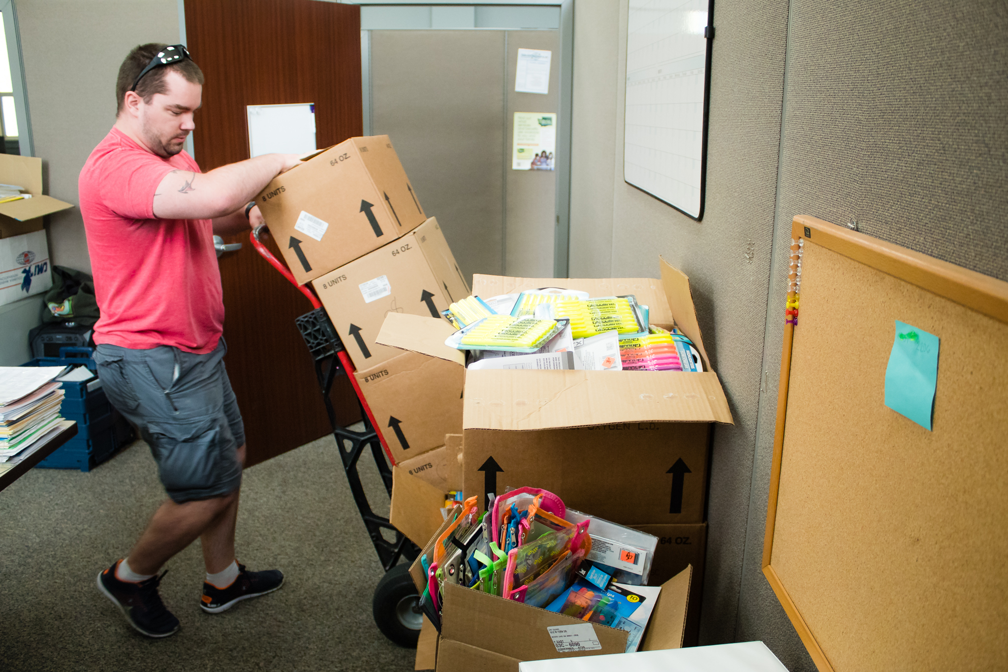 Man using a handcart moving boxes