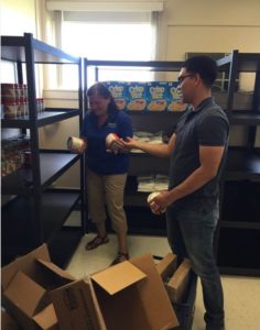 Volunteers filling the Viking Pantry shelves with food