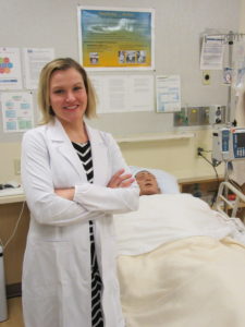 Technician standing by a manikin