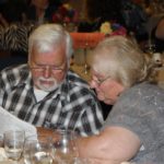 Couple looking at auction book